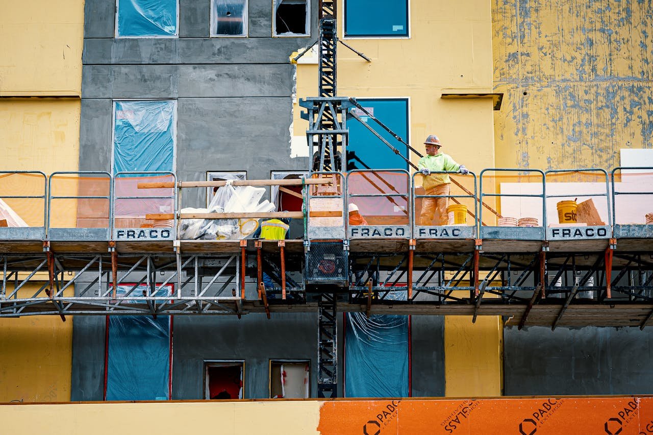 Builder on lifting platform during site works
